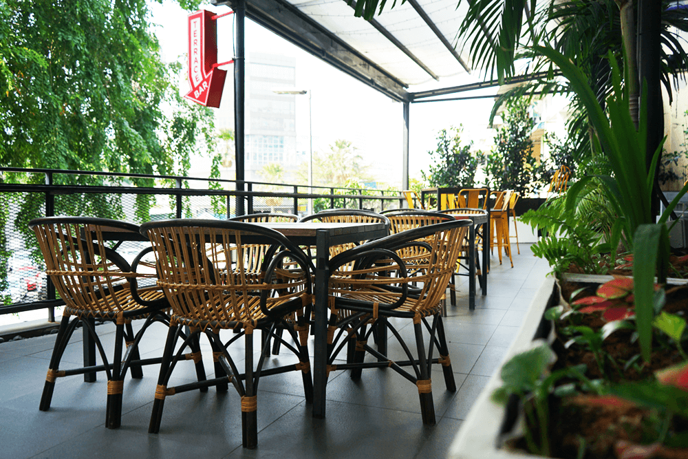Terrace event space with cane furniture at KL Journal Hotel
