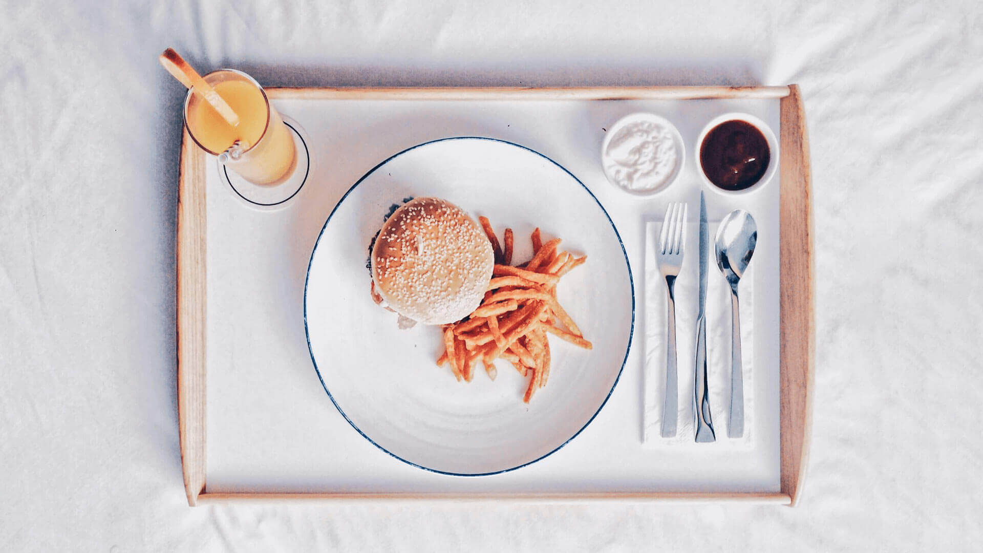 Burger dish and beverage In-room dining burger dish & beverage tray at KL Journal Hotel