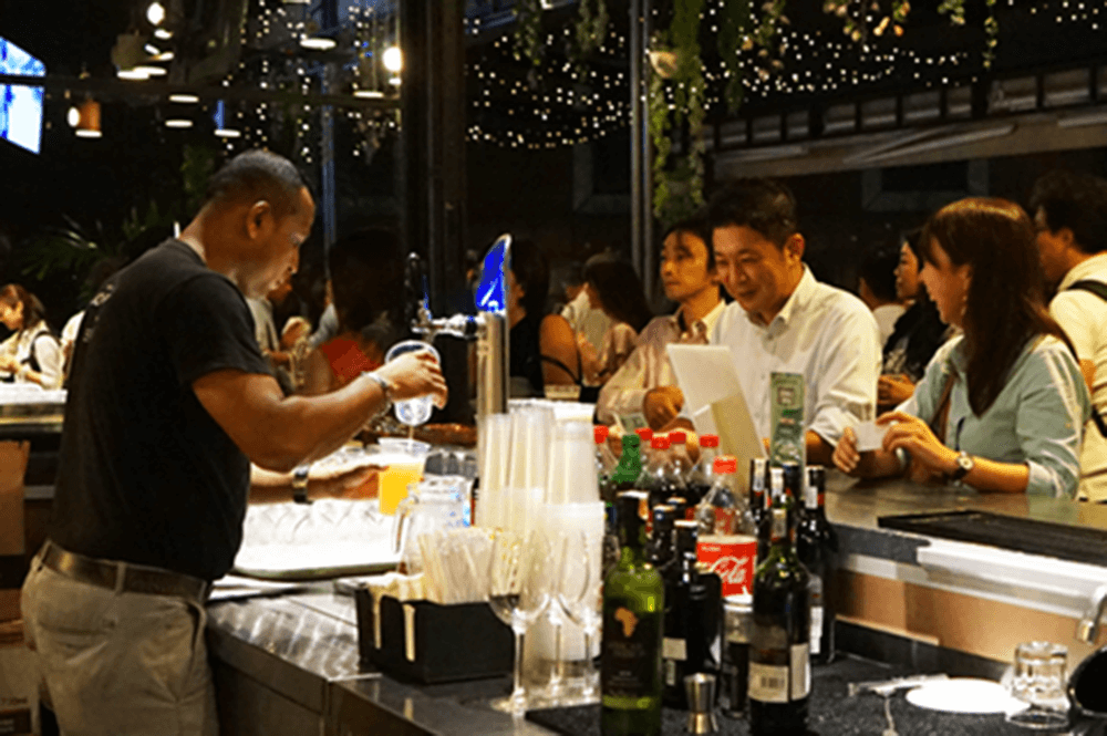 Guests at the bar of The Terrace event space at KL Journal Hotel