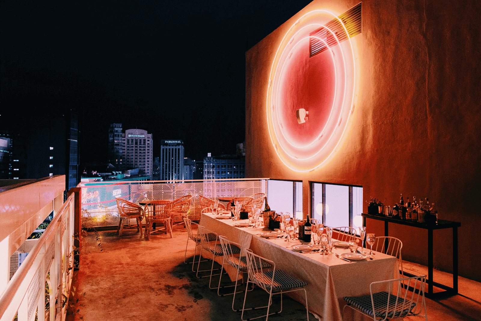 The Mezzanine event space with neon signs at The KL Journal Hotel