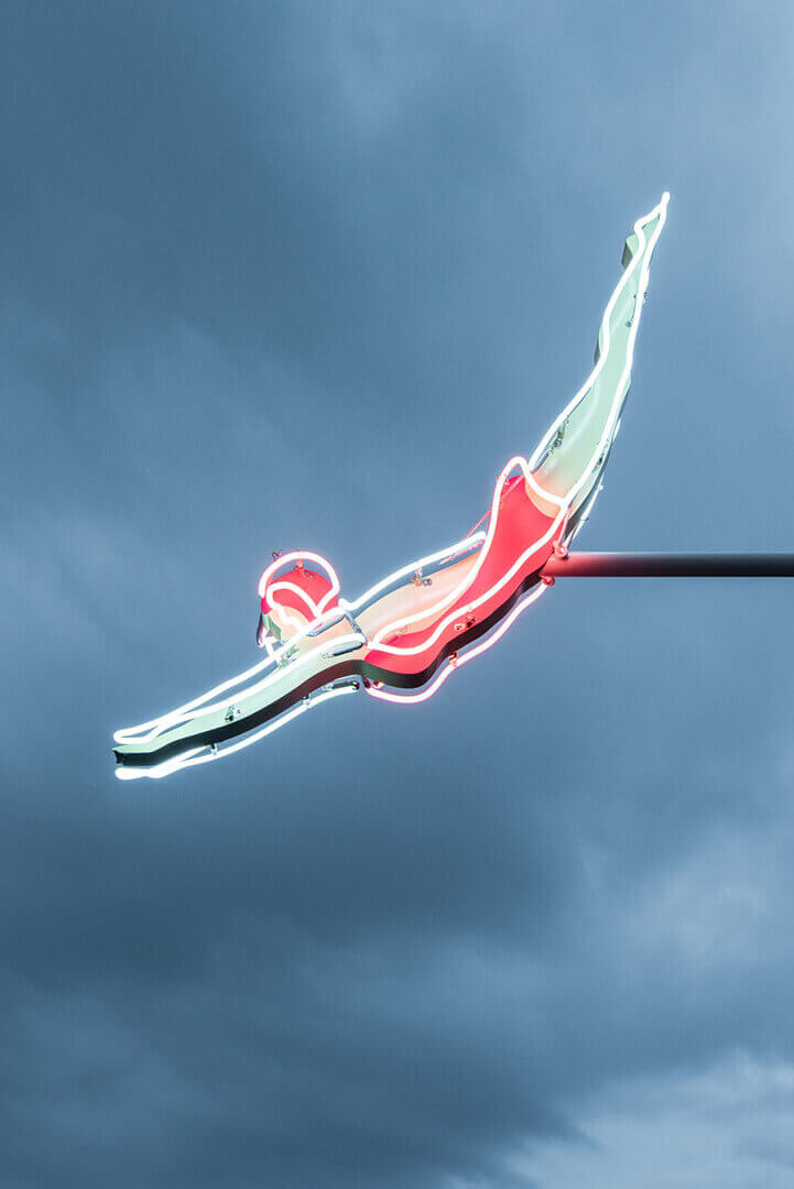 Neon sign of a person diving