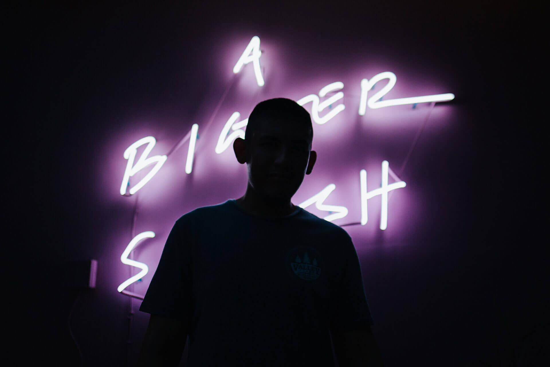 Silhouette infront of a purple neon sign at The Swimming Club