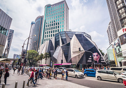 View of a busy street and skycrappers at Kuala Lumpur